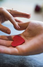 man_giving_red_ornament_heart_woman